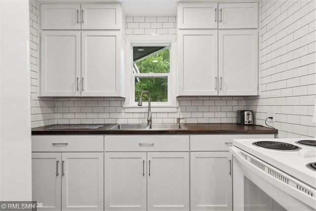 2818 Wilson Ave, Saint Croix Falls, WI 54024 - kitchen with tasteful backsplash, white cabinetry, and electric range