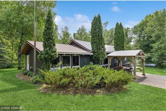 2818 Wilson Ave, Saint Croix Falls, WI 54024 - view of front of house with a front yard and a metal roof
