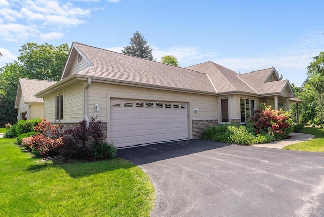 7062 S Fieldstone Ct, Franklin, WI 53132 - view of front of home with asphalt driveway, an attached garage, a front yard, brick siding, and a shingled roof
