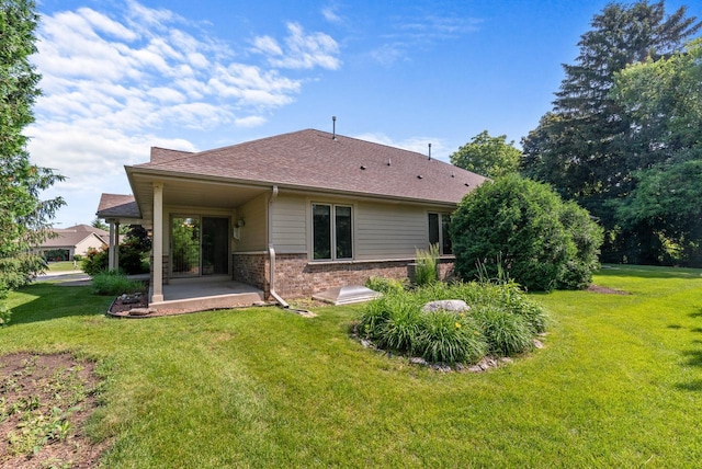 7062 S Fieldstone Ct, Franklin, WI 53132 - rear view of house featuring a lawn, a patio area, brick siding, and a shingled roof