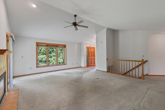 7062 S Fieldstone Ct, Franklin, WI 53132 - unfurnished living room with lofted ceiling, a ceiling fan, carpet flooring, and a tiled fireplace