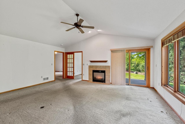 7062 S Fieldstone Ct, Franklin, WI 53132 - unfurnished living room with lofted ceiling, carpet floors, a ceiling fan, and a tiled fireplace