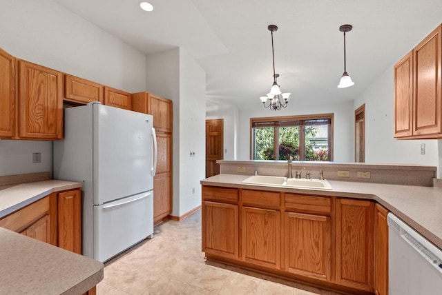 7062 S Fieldstone Ct, Franklin, WI 53132 - kitchen with white appliances, a peninsula, a chandelier, light countertops, and hanging light fixtures