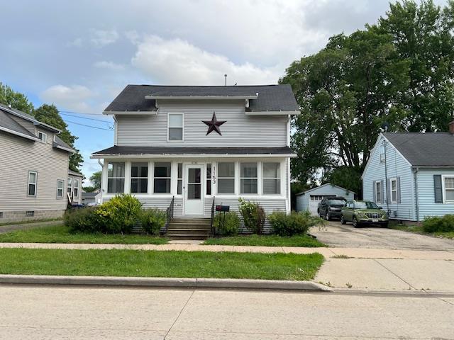 1153 W 7th Ave, Oshkosh, WI 54902 - view of front facade with an outdoor structure and a garage