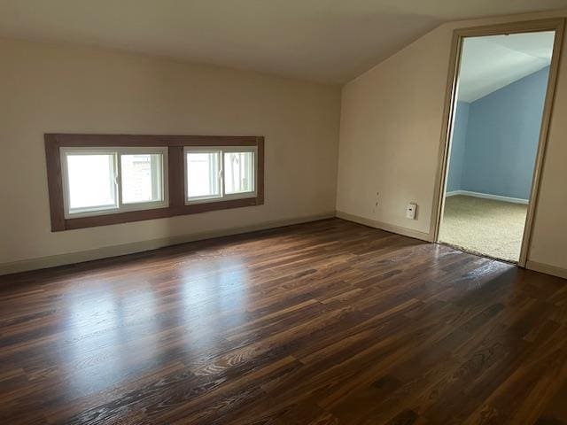 1153 W 7th Ave, Oshkosh, WI 54902 - unfurnished room featuring lofted ceiling and dark wood-style floors