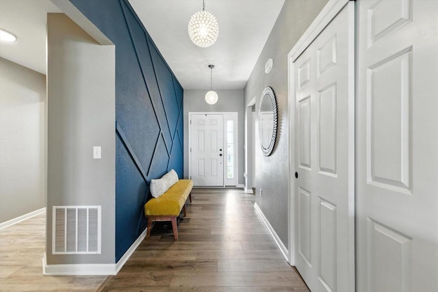 1143 Juniper Ln, Oconomowoc, WI 53066 - entryway featuring wood finished floors and a chandelier