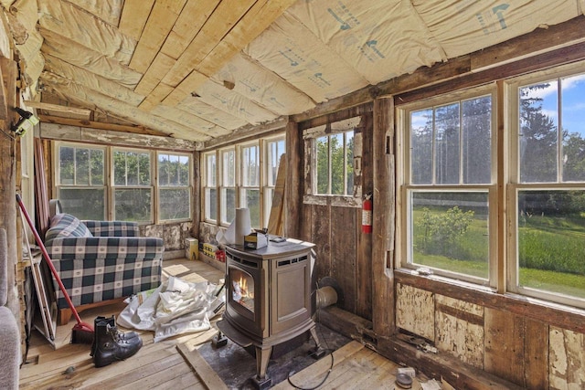 W6525 Beechnut Ave, Wild Rose, WI 54984 - sunroom / solarium featuring hardwood / wood-style floors, plenty of natural light, a wood stove, and vaulted ceiling