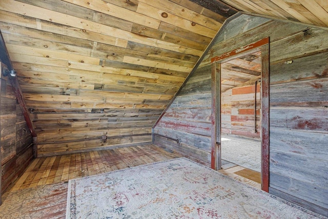 W1511 County Rd Hh, Fremont, WI 54940 - bonus room featuring vaulted ceiling, wooden walls, and hardwood / wood-style flooring