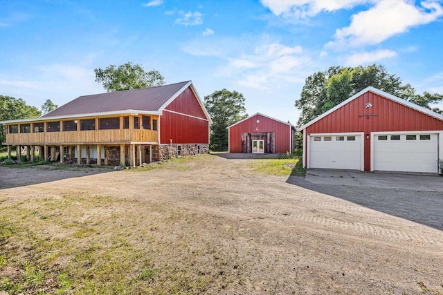 W1511 County Rd Hh, Fremont, WI 54940 - view of front of home featuring a detached garage, an outdoor structure, and a metal roof