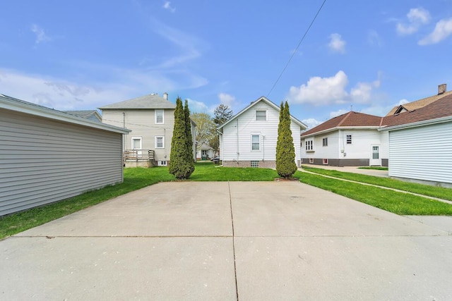 1235 Grove Ave, Racine, WI 53405 - back of house featuring a lawn and a residential view