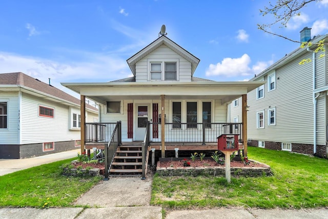 1235 Grove Ave, Racine, WI 53405 - view of front facade featuring a porch and a front yard