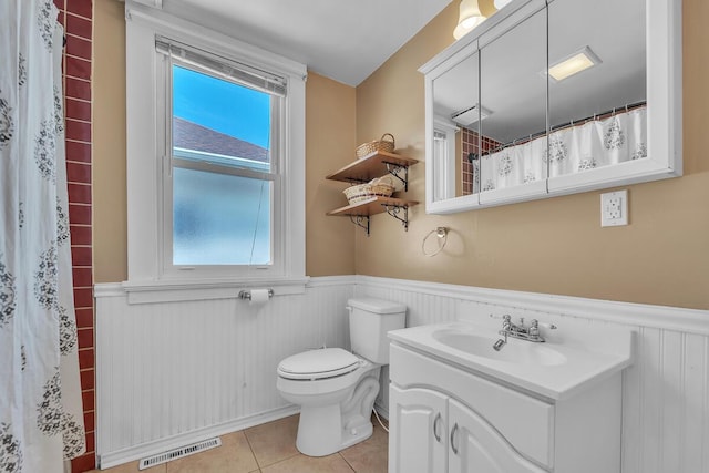 1235 Grove Ave, Racine, WI 53405 - full bath featuring wainscoting, vanity, tile patterned floors, and a shower with shower curtain