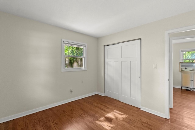 5717 S 42nd St, Greenfield, WI 53221 - unfurnished bedroom featuring wood finished floors and a closet