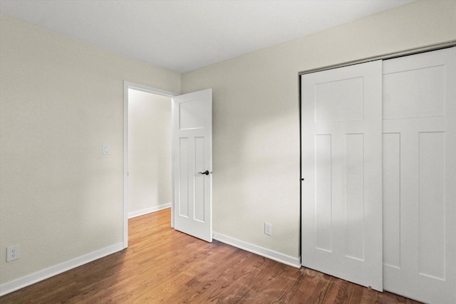 5717 S 42nd St, Greenfield, WI 53221 - unfurnished bedroom with wood finished floors and a closet