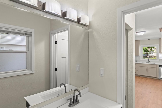 5717 S 42nd St, Greenfield, WI 53221 - bathroom with wood finished floors, vanity, and a textured wall