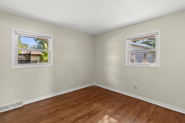 5717 S 42nd St, Greenfield, WI 53221 - spare room featuring wood finished floors and plenty of natural light