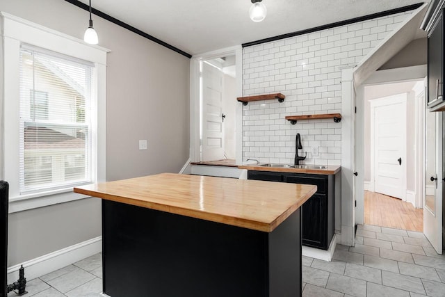 716 Vernon Ave, Beloit, WI 53511 - kitchen with wood counters, light tile patterned flooring, open shelves, pendant lighting, and dark cabinetry