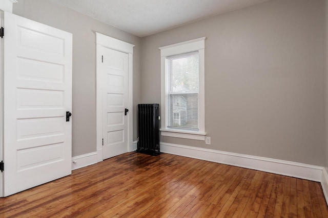 716 Vernon Ave, Beloit, WI 53511 - unfurnished bedroom with radiator and hardwood / wood-style floors