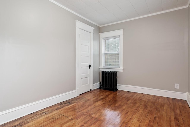 716 Vernon Ave, Beloit, WI 53511 - unfurnished room featuring radiator heating unit, ornamental molding, and wood-type flooring