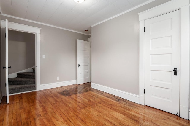 716 Vernon Ave, Beloit, WI 53511 - unfurnished bedroom with crown molding and light wood-style floors