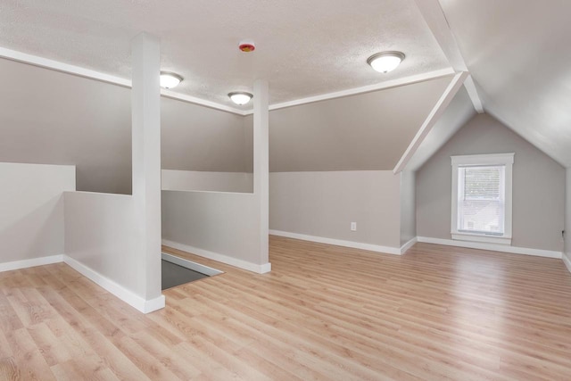 716 Vernon Ave, Beloit, WI 53511 - additional living space featuring wood finished floors, lofted ceiling, and a textured ceiling