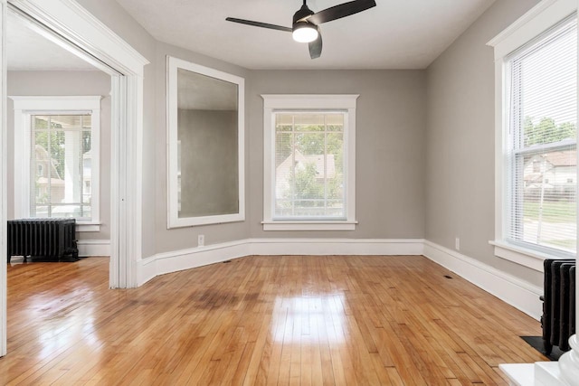 716 Vernon Ave, Beloit, WI 53511 - empty room featuring radiator heating unit, light wood-style floors, and ceiling fan
