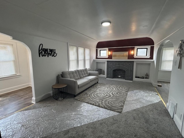 3041 N 52nd St, Milwaukee, WI 53210 - living room featuring arched walkways and a brick fireplace