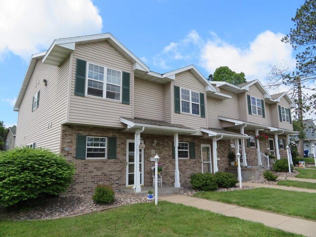 306 N Sales St Unit # 1, Merrill, WI 54452 - view of property featuring brick siding and a front yard