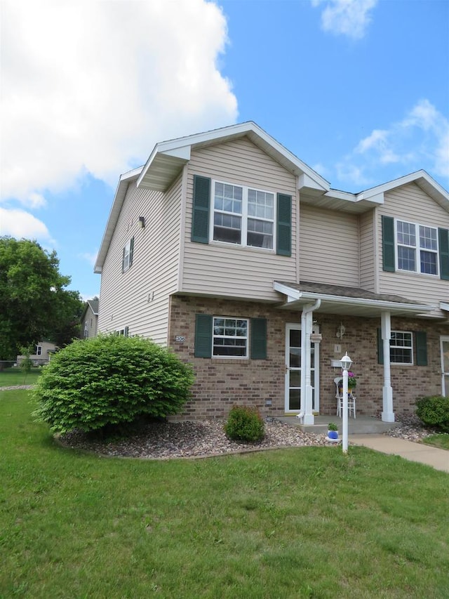 306 N Sales St Unit # 1, Merrill, WI 54452 - view of front of property featuring brick siding and a front lawn