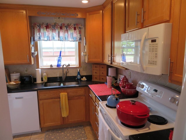 306 N Sales St Unit # 1, Merrill, WI 54452 - kitchen with white appliances, plenty of natural light, backsplash, and brown cabinets