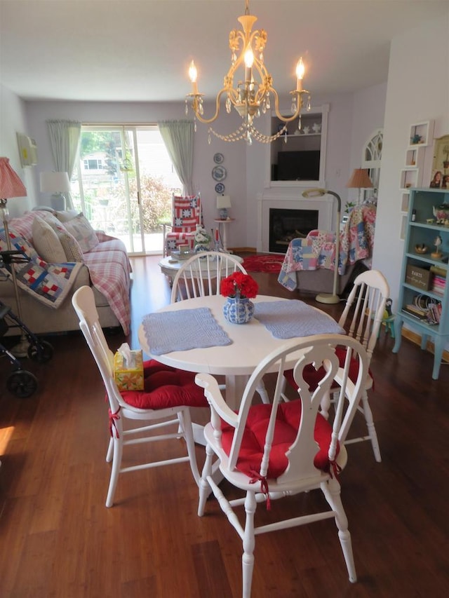 306 N Sales St Unit # 1, Merrill, WI 54452 - dining area with a chandelier, wood finished floors, and a fireplace