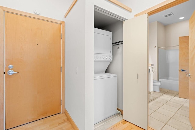 530 W Doty St Unit 107, Madison, WI 53703 - washroom featuring estacked washer and dryer and light wood-style floors