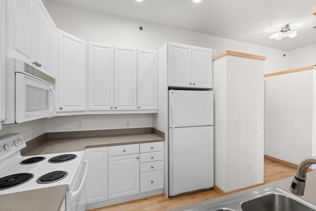 530 W Doty St Unit 107, Madison, WI 53703 - kitchen with white appliances, white cabinetry, and light wood finished floors