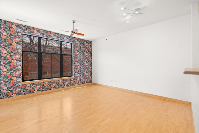 530 W Doty St Unit 107, Madison, WI 53703 - unfurnished room featuring wallpapered walls, wood finished floors, and a ceiling fan