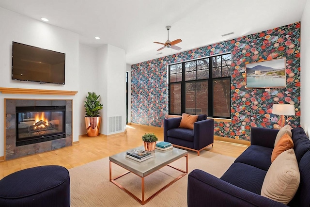 530 W Doty St Unit 107, Madison, WI 53703 - living area featuring wallpapered walls, wood finished floors, a ceiling fan, a tiled fireplace, and recessed lighting