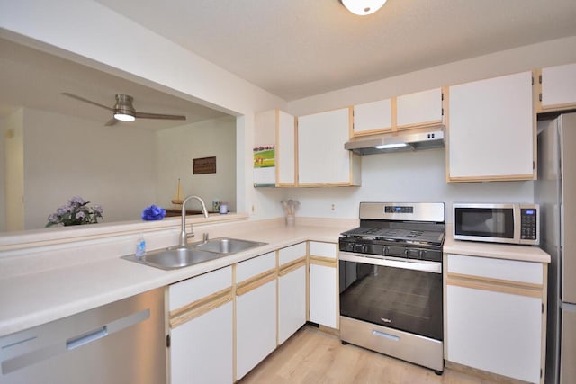 W192S7850 Overlook Bay Rd Unit 3, Muskego, WI 53150 - kitchen with stainless steel appliances, under cabinet range hood, light countertops, light wood-type flooring, and ceiling fan