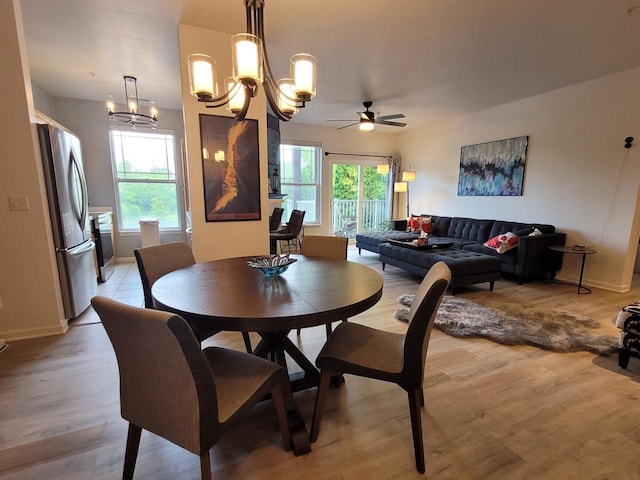 N113W16241 Sylvan Cir Unit 110, Germantown, WI 53022 - dining room featuring healthy amount of natural light, light wood-style flooring, a chandelier, and ceiling fan