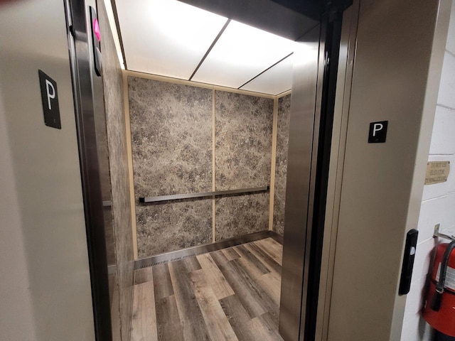N113W16241 Sylvan Cir Unit 110, Germantown, WI 53022 - bathroom featuring elevator and wood finished floors