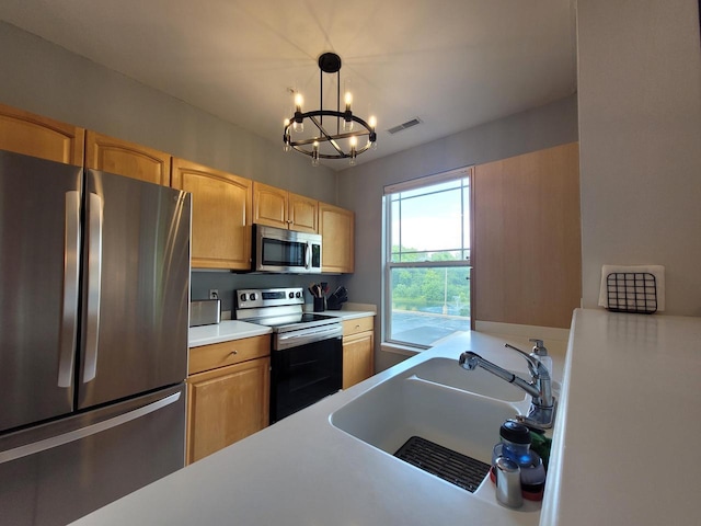 N113W16241 Sylvan Cir Unit 110, Germantown, WI 53022 - kitchen featuring appliances with stainless steel finishes, a chandelier, light countertops, pendant lighting, and light brown cabinets