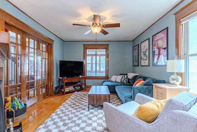 1756 Church St, Stevens Point, WI 54481 - living area with ceiling fan, wood finished floors, healthy amount of natural light, ornamental molding, and french doors