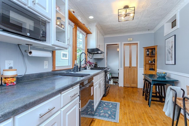 1756 Church St, Stevens Point, WI 54481 - kitchen featuring black appliances, white cabinets, an ornate ceiling, glass insert cabinets, and light wood-type flooring
