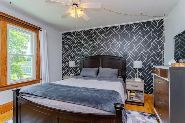 1756 Church St, Stevens Point, WI 54481 - bedroom featuring wood finished floors, ornamental molding, an accent wall, and a ceiling fan