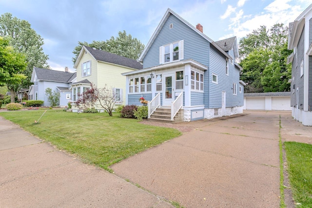 1756 Church St, Stevens Point, WI 54481 - view of front facade with entry steps, a chimney, an outbuilding, a detached garage, and a front lawn