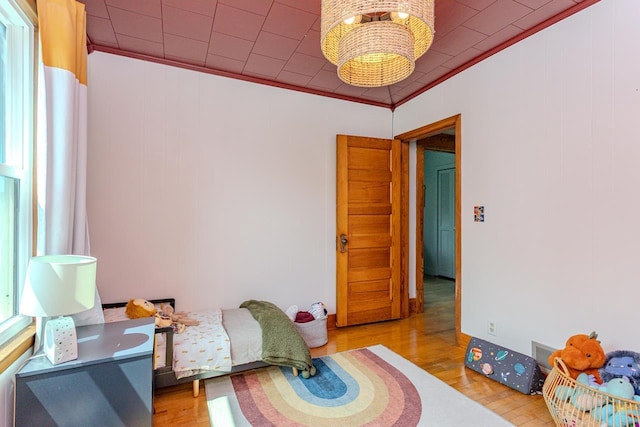 1756 Church St, Stevens Point, WI 54481 - bedroom with crown molding, wood finished floors, and a chandelier