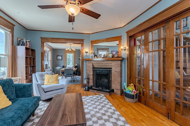 1756 Church St, Stevens Point, WI 54481 - living area featuring wood finished floors, ceiling fan, ornamental molding, and a brick fireplace