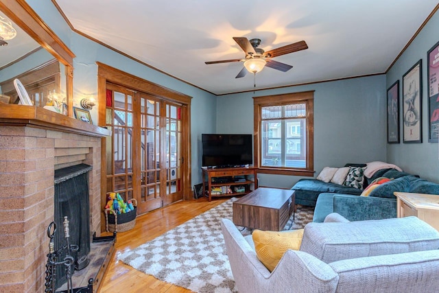 1756 Church St, Stevens Point, WI 54481 - living area featuring wood finished floors, a ceiling fan, a fireplace, and crown molding