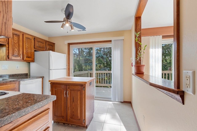 1820 Ridgeway Dr Unit 12A, De Pere, WI 54115 - kitchen with white appliances, ceiling fan, brown cabinetry, and light tile patterned floors