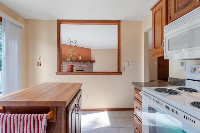 1820 Ridgeway Dr Unit 12A, De Pere, WI 54115 - kitchen featuring white appliances, light tile patterned flooring, and brown cabinetry