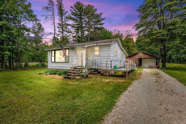 W914 Madsen Rd, Marinette, WI 54143 - view of front of home with an outdoor structure, a lawn, driveway, and a garage