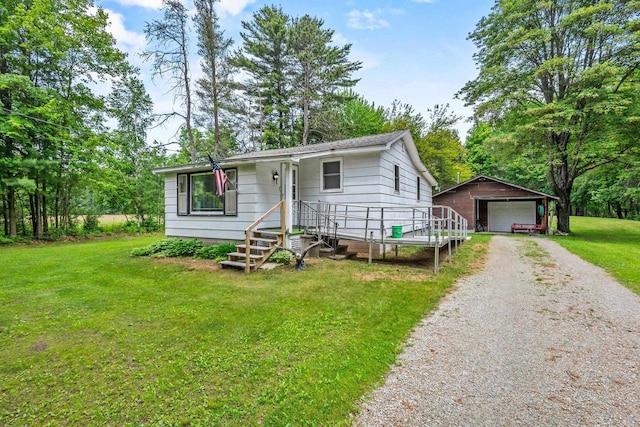 W914 Madsen Rd, Marinette, WI 54143 - view of front of home with an outdoor structure, a front yard, and a detached garage